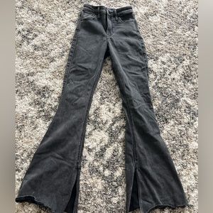 Black Hollister Flare Jeans, with a slit on the inside of the leg.